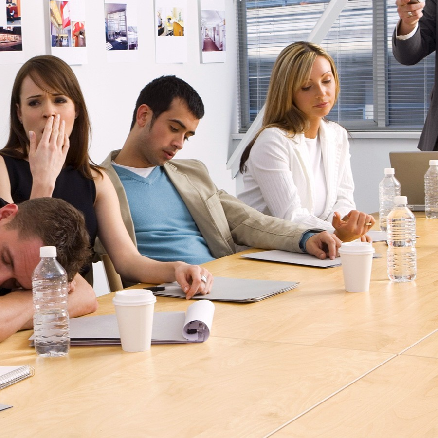 Business people sitting bored in a meeting